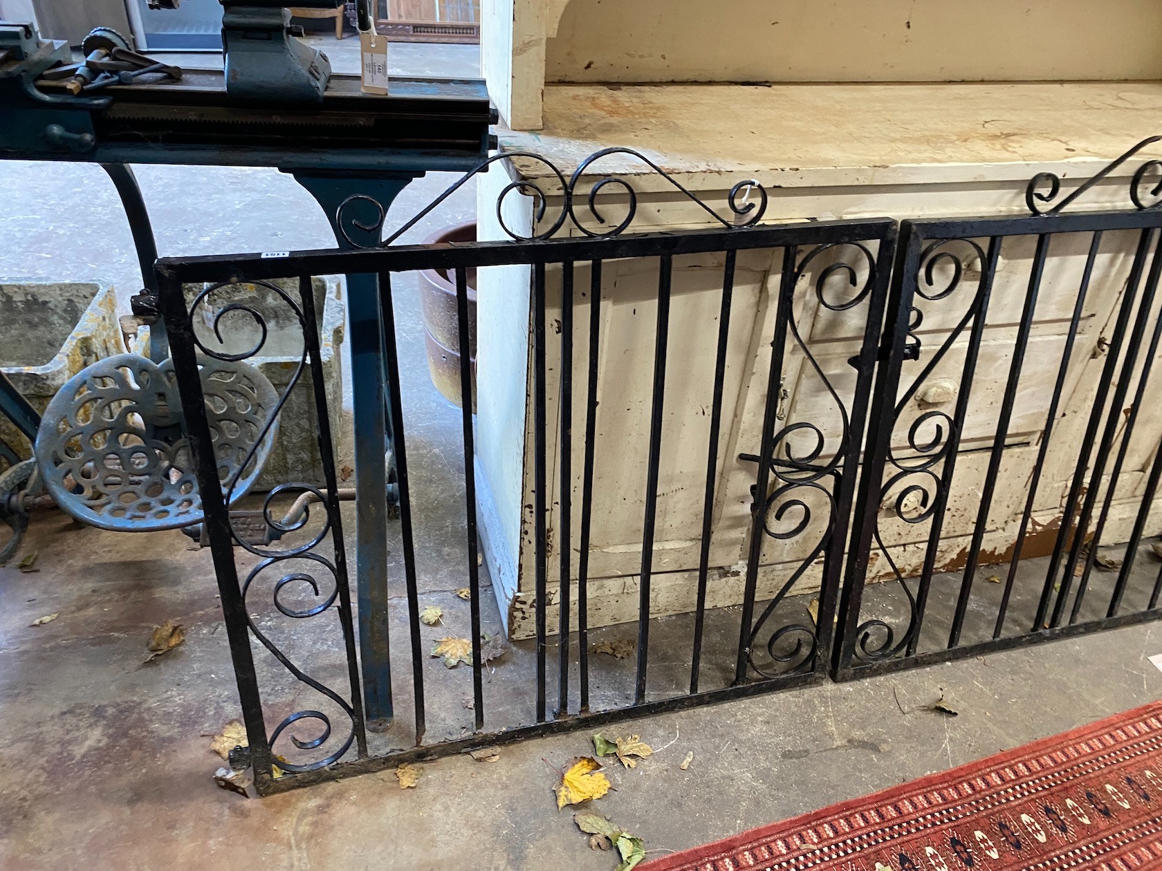 A pair of painted wrought iron garden gates, each gate width 101cm, height 99cm together with a Victorian cast iron campana urn section
